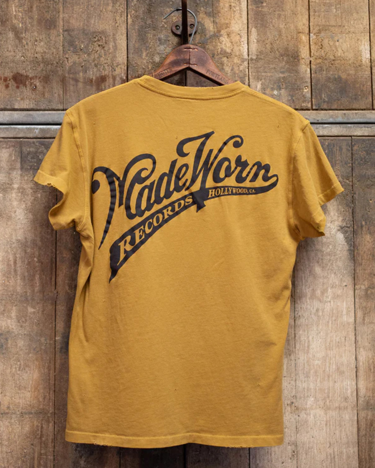 The Made Worn Pocket Tee MadeWorn Records is a mustard yellow, vintage unisex 100% cotton shirt with a back print that says "MadeWorn RECORDS HOLLYWOOD, CA." Proudly made in the USA.