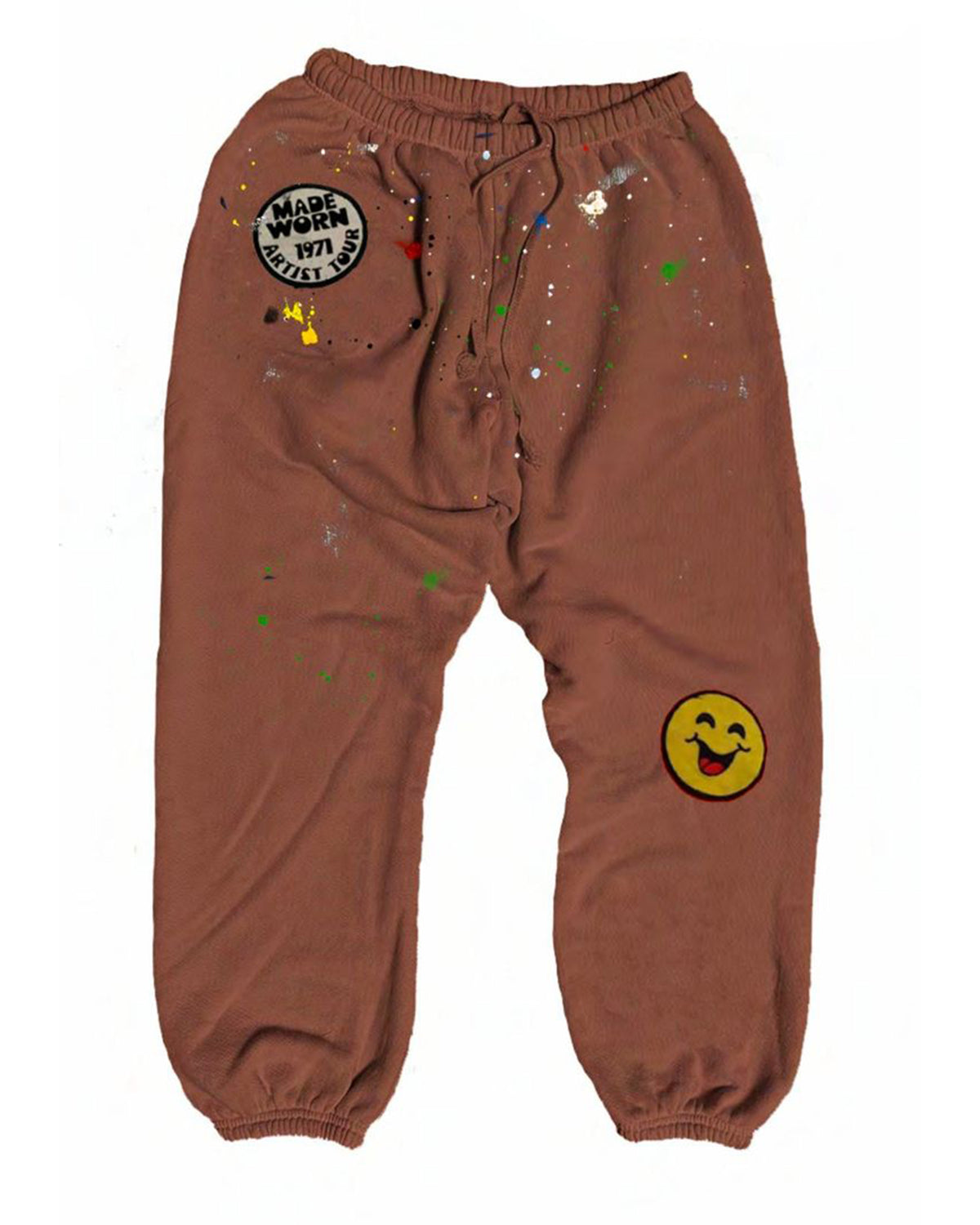 MadeWorn P.E. Sweatpants by Made Worn: heavyweight brown French terry joggers with elastic cuffs, colorful paint splatters, a round "MADE WORN 1971 ARTIST SH*T" patch on the left thigh, and a yellow smiley face patch on the right knee. Unisex fit.