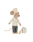 The Maileg Chef Mouse W/ Pot / Big Brother plush by Maileg wears a white chef's hat, coat, and checkered pants, standing beside a silver pot and wooden spoon playset on a white background.