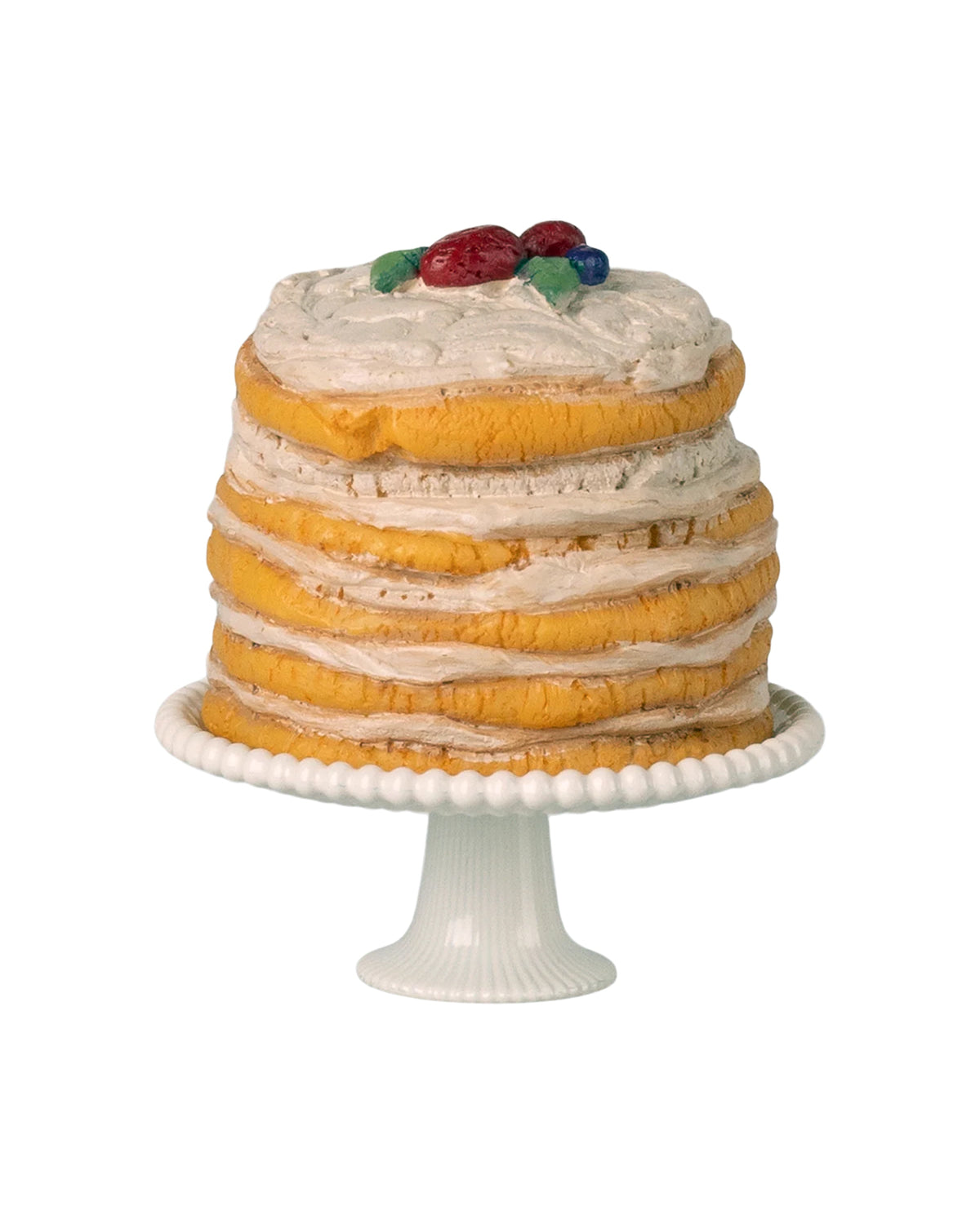The Maileg Party cake and cake stand, Mouse - Off White, features layers of cake with cream filling and colorful fruit accents. This delightful piece is an ideal party decoration, standing out beautifully against a white background.