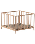 The Maileg Playpen, My - Rose is a small beige playpen with vertical bars and a floral-patterned cushioned mat inside, displayed on a white background.