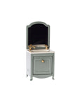 The Maileg Sink Dresser is a small, vintage-style miniature vanity featuring a rectangular mirror, brass faucet, white countertop, and green farmhouse cabinet with a gold knob—perfect for bathroom sink displays.