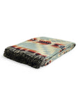 Folded Secoya throw blanket in vibrant mint with a geometric Southwestern pattern and fringe by Bungalow Furniture.