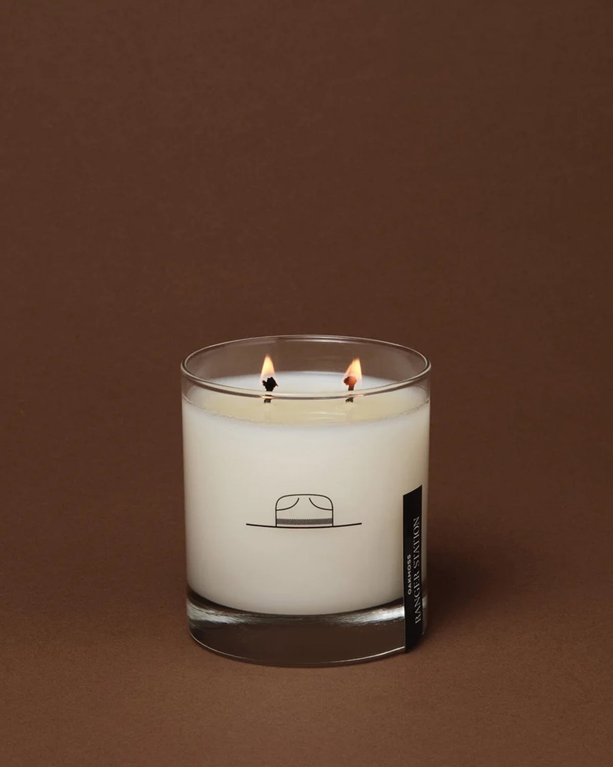 Double-wick Oak Moss candle in a glass jar with a minimalist hat illustration from Bungalow Furniture & Accessories.