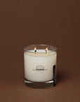 Double-wick Oak Moss candle in a glass jar with a minimalist hat illustration from Bungalow Furniture & Accessories.