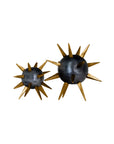 The Import Collection Punk Candleholder set features two metallic spheres with bold gold spikes—one large, one small—offering striking industrial decor for your space. Displayed against a white background, these unique pieces make a standout accent.