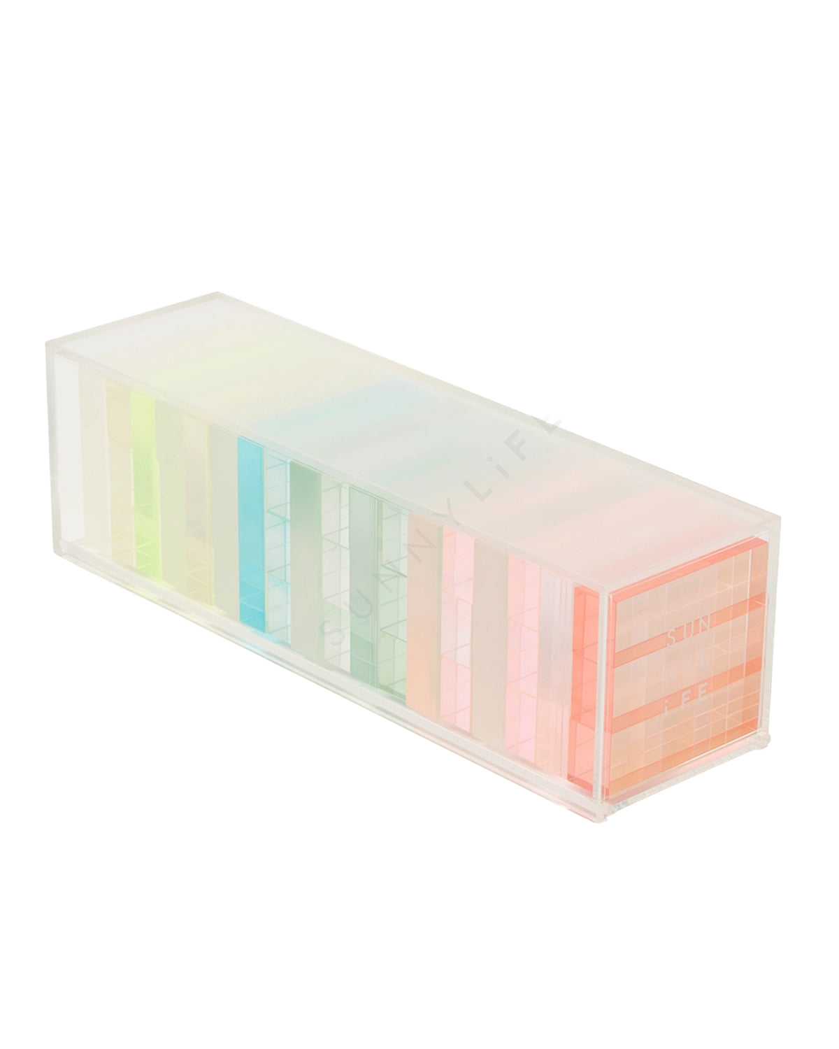 The Faire Ombre Lucite Sherbert Jumbling Tower Stacking Game features a transparent rectangular case with pastel, translucent dividers that create a rainbow effect, giving this stylish game set a retro vibe.