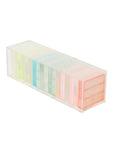 The Faire Ombre Lucite Sherbert Jumbling Tower Stacking Game features a transparent rectangular case with pastel, translucent dividers that create a rainbow effect, giving this stylish game set a retro vibe.