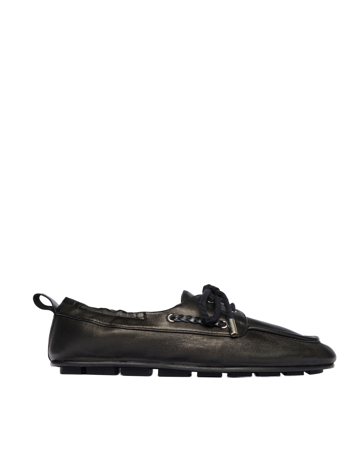 The Freda Salvador RIA Driver Loafer, shown in profile against a white background, is a black Nappa leather moccasin-style shoe with a flat rubber sole, decorative upper lacing, and a small heel pull tab.