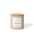 A Faire "Rich Hippie" 14oz. beige soy wax candle jar with a wooden lid rests on a white background, casting a soft shadow to the right.