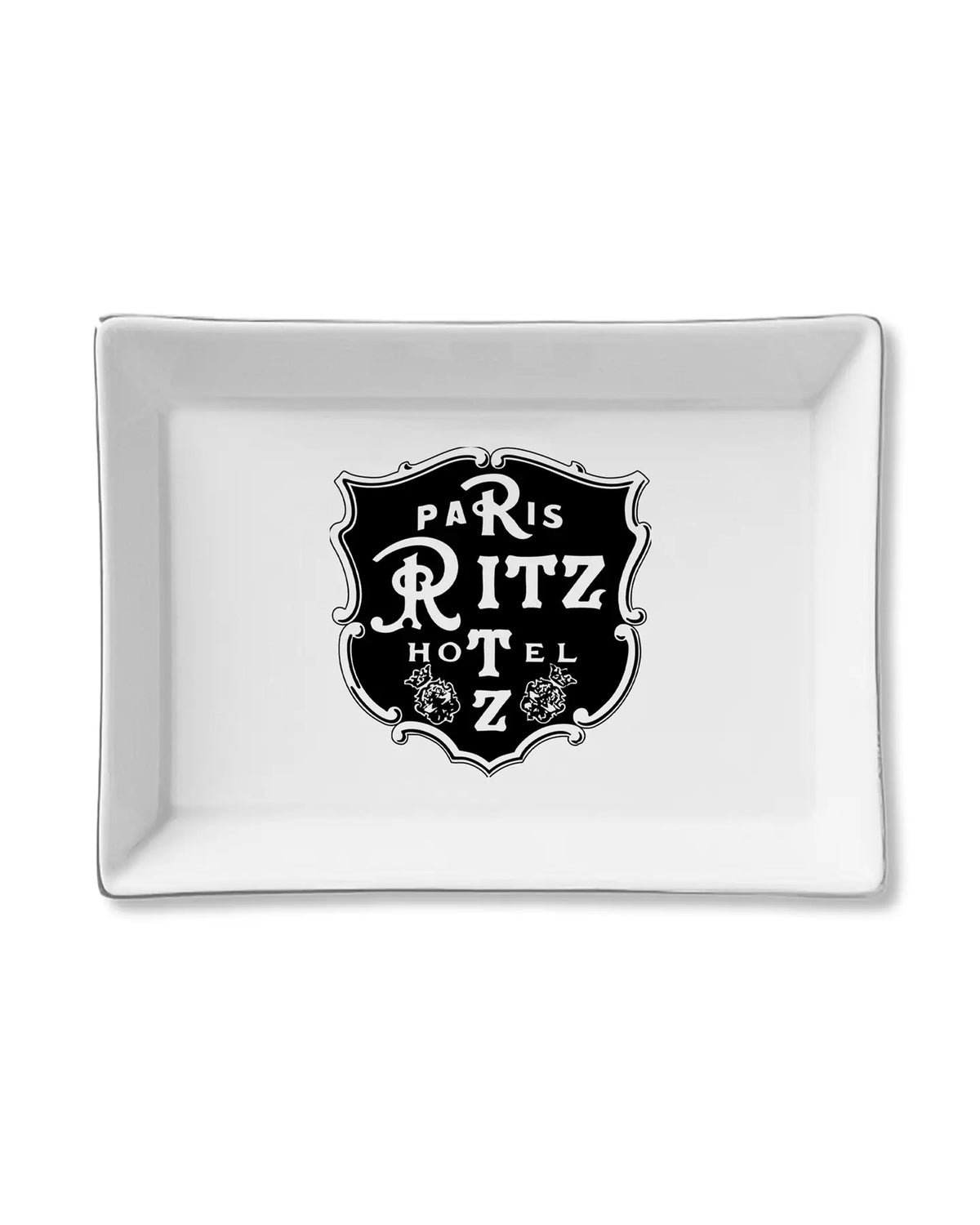 The Faire Ceramic Tray is a rectangular white organizer with a vintage-style "Paris Ritz Hotel" emblem and floral accents—ideal as a jewelry holder or trinket tray gift.