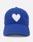 The KR Imperfect Heart Hat by Kerri Rosenthal is a royal blue baseball cap with a white embroidered heart patch on the front, shown against a plain white background.