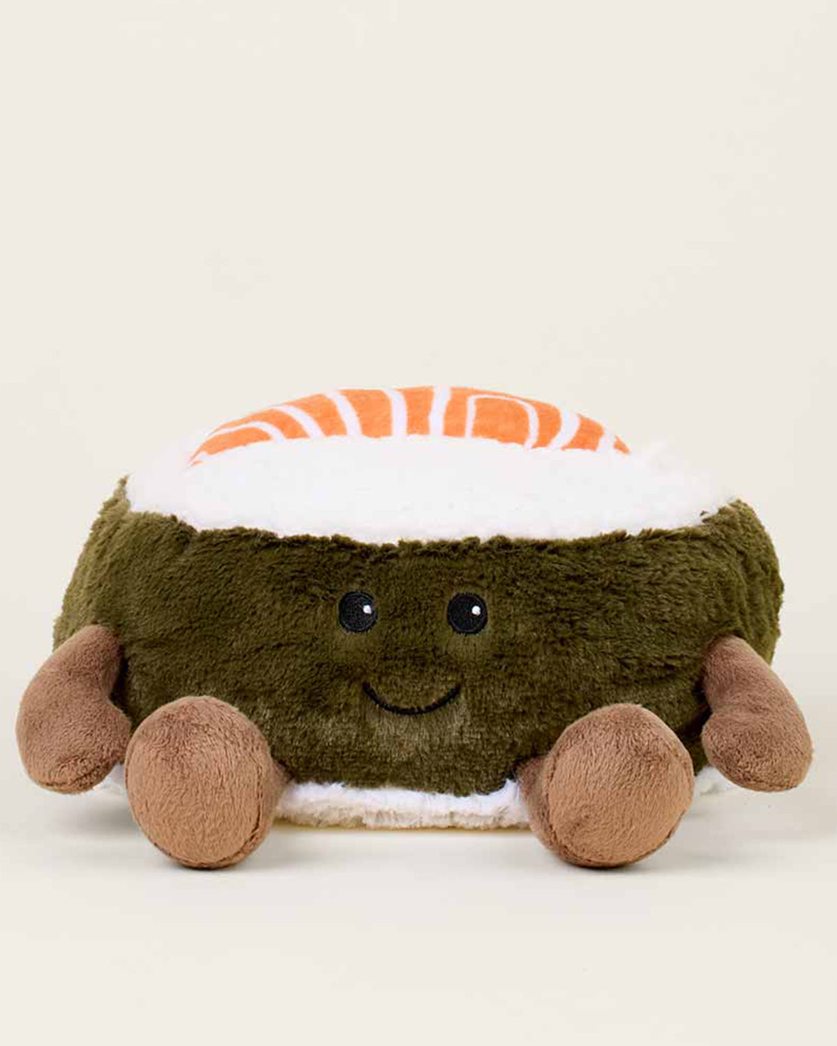 The Salmon Sushi Warmies by Faire is a lavender-scented plush toy shaped like a smiling sushi roll with a brown base, white rice, orange-striped top, and four small limbs, shown against a plain light background.