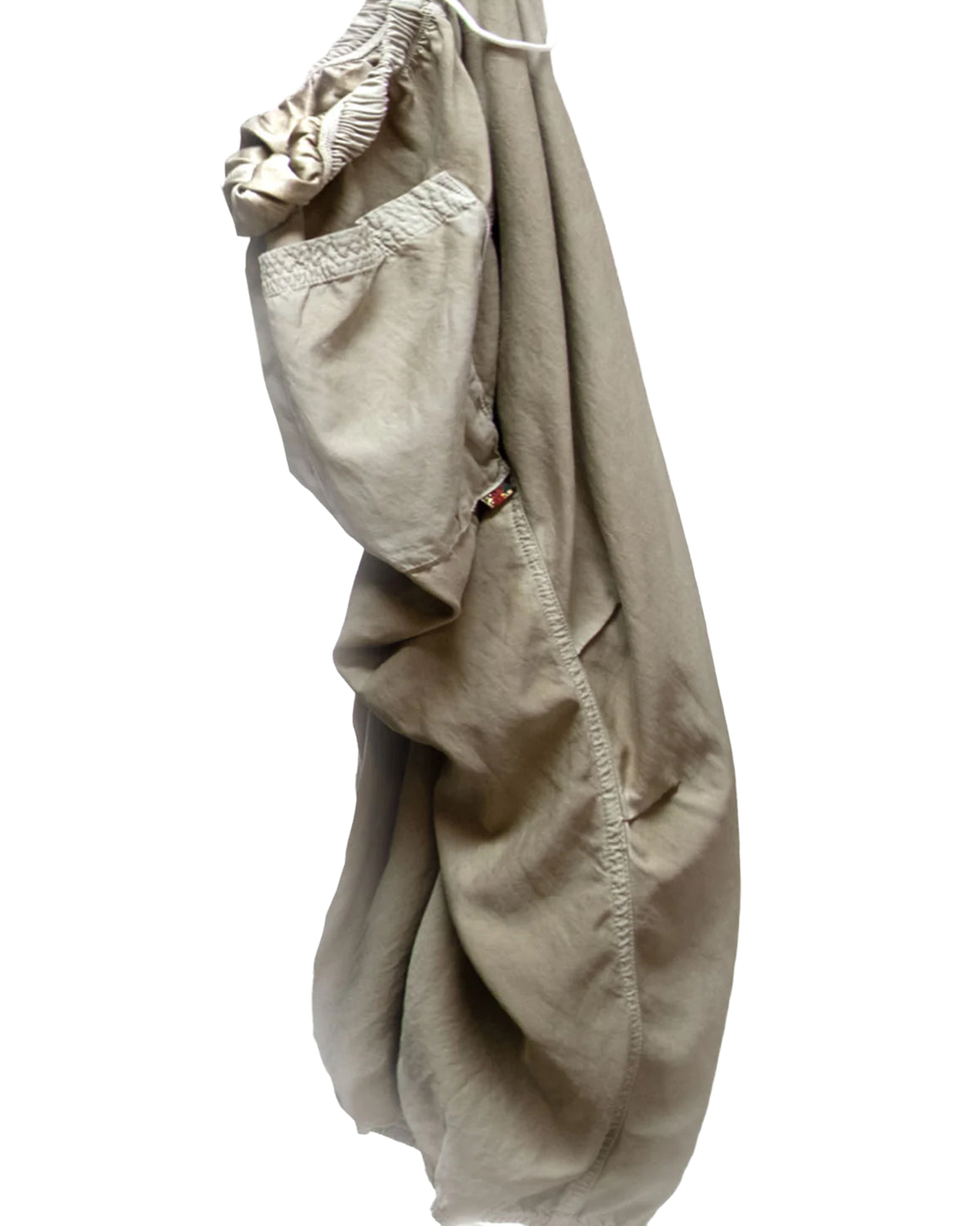 The Matte/Satin Biggy Pant by Free City (sparrow, LLC): loose drawcord pants with an elastic waistband, side pocket, and oversized fit, shown hanging against a white background.