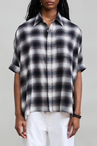 Denimist EMMA black and white plaid shirt styled with white pants, simple background, for Bungalow Furniture & Accessories.