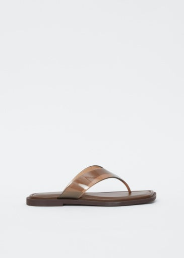 The Rag & Bone gracie jelly thong, a brown sandal with a flat sole and glossy wide strap, features a geometric square toe and is displayed against a plain white background.