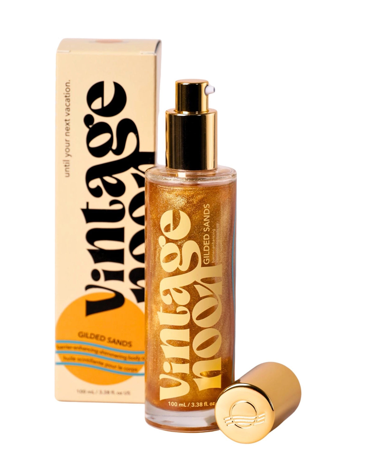 A gold bottle of Faire Shimmer Body Oil with a pump top stands before its branded box, featuring bold black and gold text that highlights its luxurious formula to enhance your skin's moisture barrier and radiant glow.