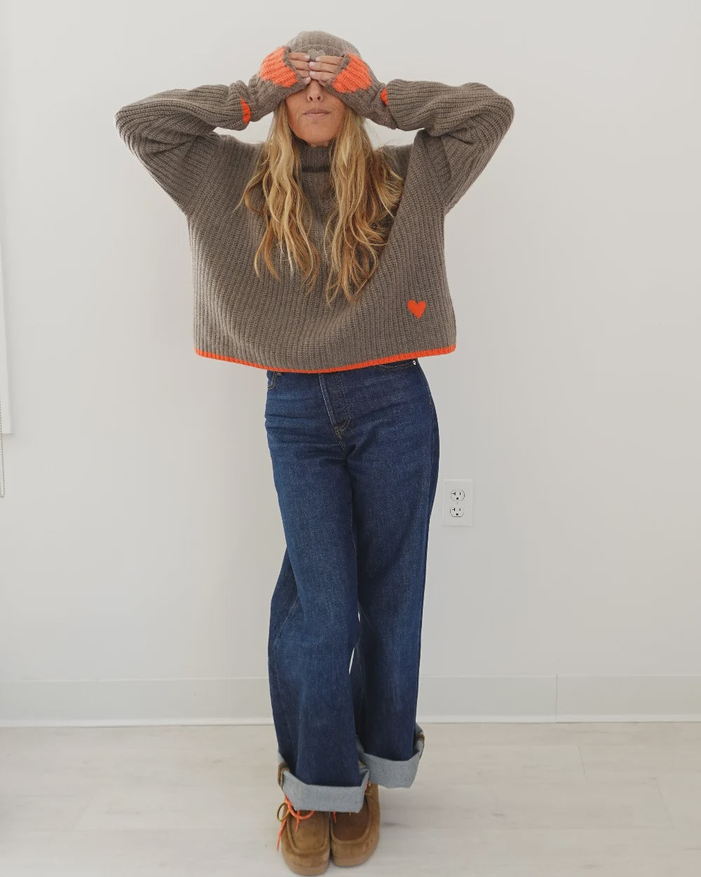 Brown rib-knit turtleneck by Kerri Rosenthal, featuring a wool-cashmere blend with orange trim and heart detail.