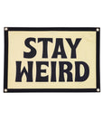 Black “Stay Weird” flag by The Faire, 16x24 inches, adds a quirky accent to walls; bold lettering for playful decor.