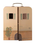 The Maileg SuitCasa Little Sis & Bro by Maileg is a charming suitcase mouse house with a house facade, blue shutters, painted flowers, and opening doors that reveal a patterned interior—perfect for portable adventures or toy accessories.