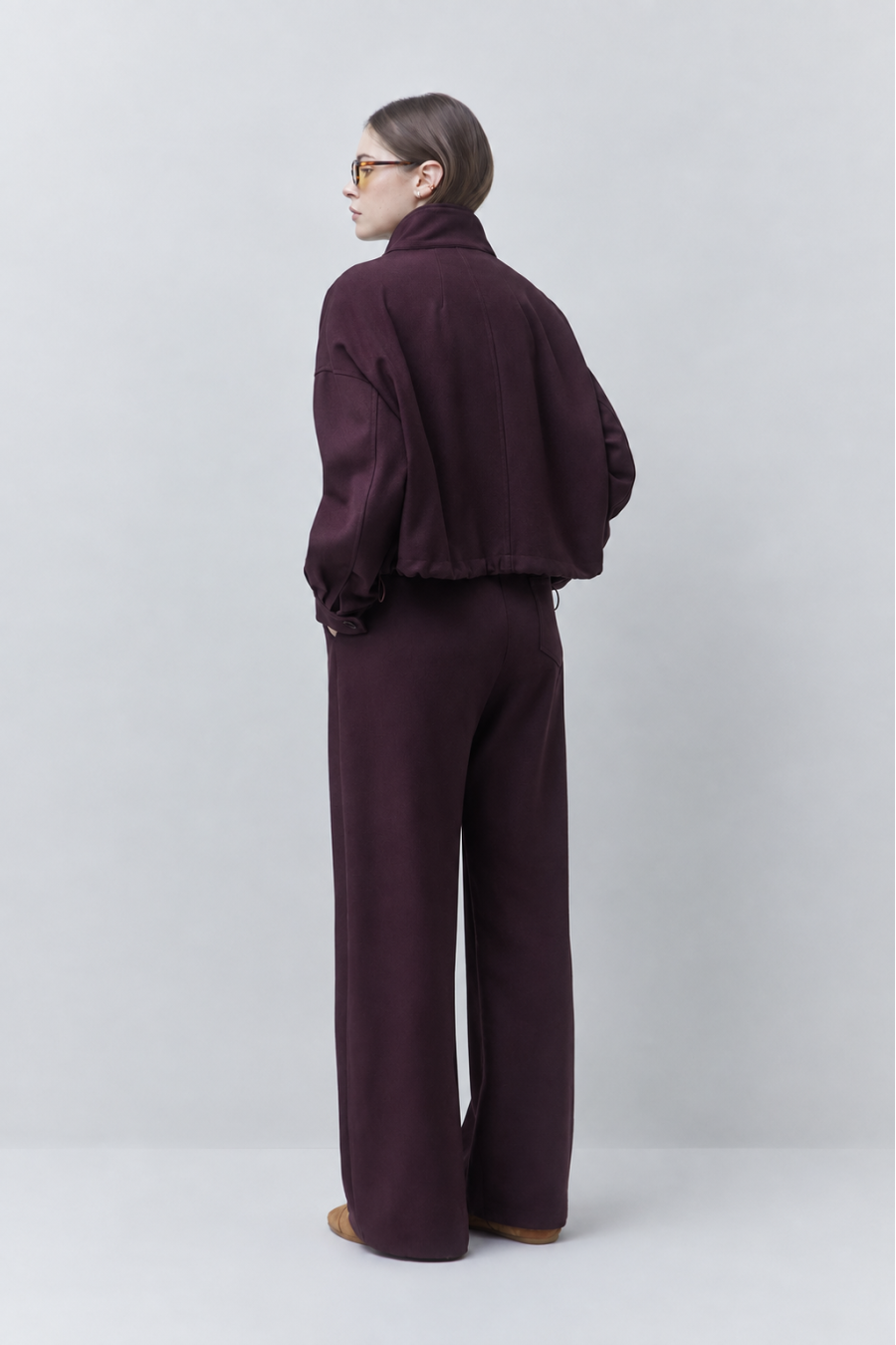 Maroon Jio jacket with wide-leg pants by SUNCOO, model stands facing away against a plain backdrop.
