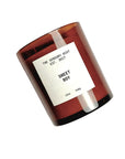 A brown 12 oz SWEET BOY soy wax candle by Faire sits tilted against a white background. The jar features a white rectangular label and offers clean-burning, non-toxic fragrance.