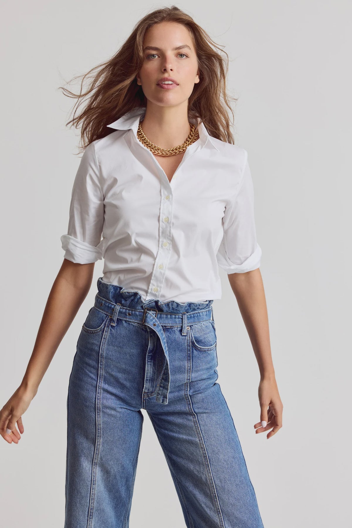 3/4 sleeve Essentials Icon Shirt by THE SHIRT styled with a gold necklace and high-waisted jeans, neutral backdrop.