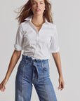 3/4 sleeve Essentials Icon Shirt by THE SHIRT styled with a gold necklace and high-waisted jeans, neutral backdrop.