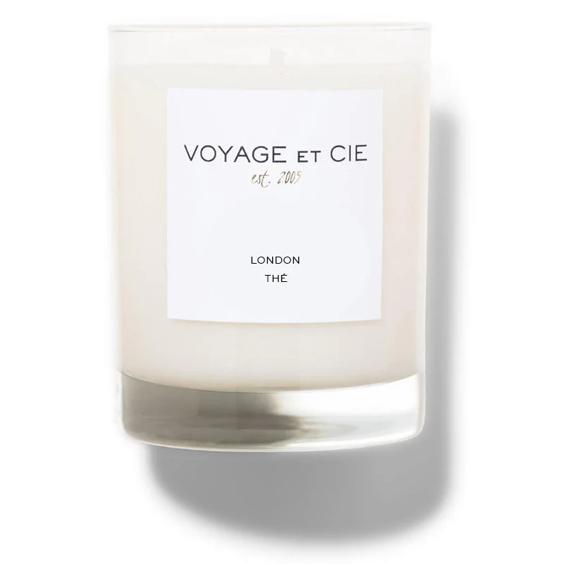 The 14 OZ Classic Highball by Voyage Et Cie is a white soy coconut blend candle in a clear glass jar with a "VOYAGE ET CIE est. 2005 LONDON THÉ" label—an elegant, sustainable organic addition to your collection.