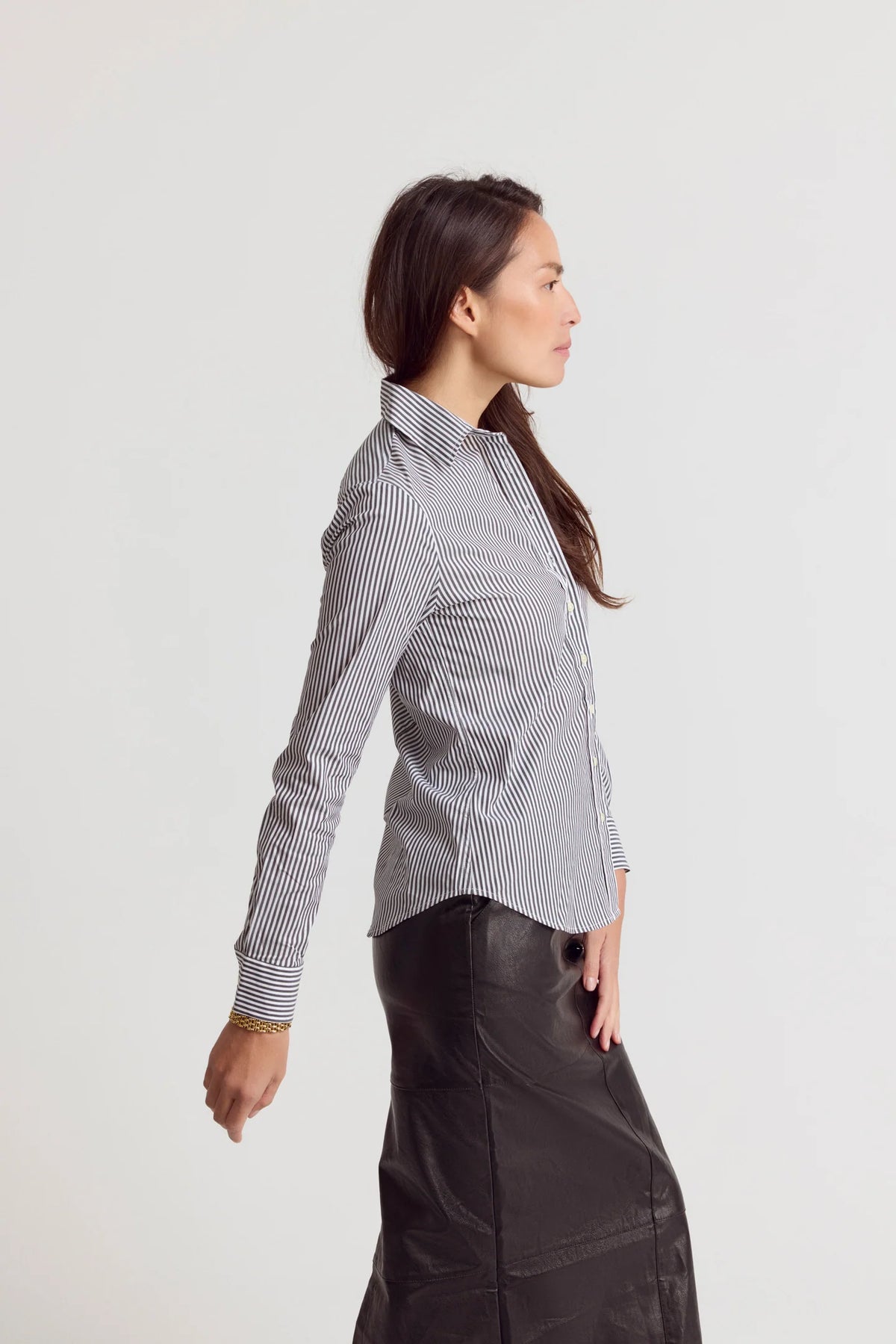 Striped Icon Shirt by THE SHIRT paired with black skirt, shown in profile against a white background.