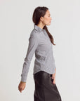 Striped Icon Shirt by THE SHIRT paired with black skirt, shown in profile against a white background.