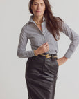 THE SHIRT Icon Shirt in striped pattern with No Gape tech, paired with a black leather skirt, model posing.