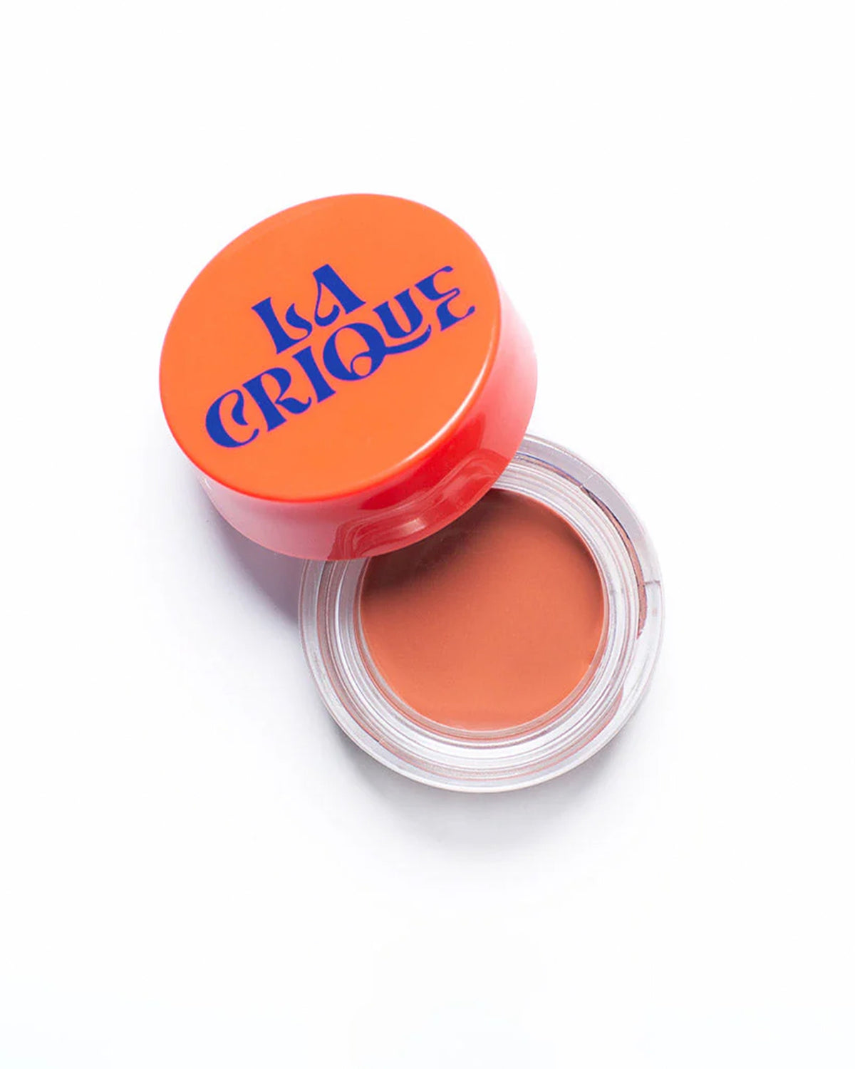 An open round container of Faire's 01 Tinted Lip Balm & Blush with an orange lid, labeled "Faire" in bold blue letters, reveals a warm nude cream infused with hyaluronic acid against a white background.