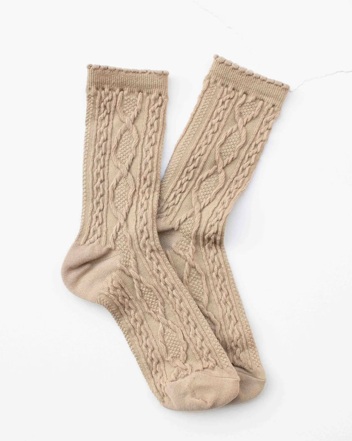 The Faire Twist Cotton Crew Socks in light brown feature a cable knit textured pattern and are laid side by side on a white background—perfect women’s socks for cozy, stylish comfort.