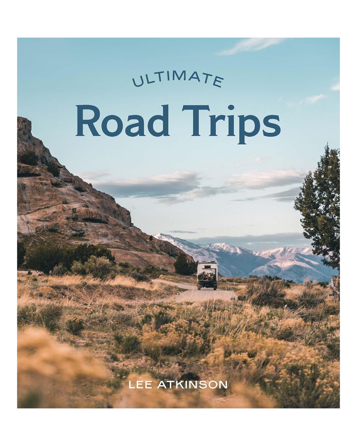 Book cover for "Ultimate Road Trips" by Hachette Book Group, showing a car on a dirt road through stunning scenery—ideal inspiration for unforgettable driving holidays and top road trip destinations.