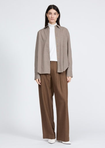 Rag &amp; Bone Connie plaid shirt in charcoal grey worn over a white turtleneck and brown wide-leg trousers.