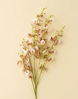 Light pink Faire Wild Orchid Spray stems from Bungalow Furniture add a touch of elegance to neutral home decor.