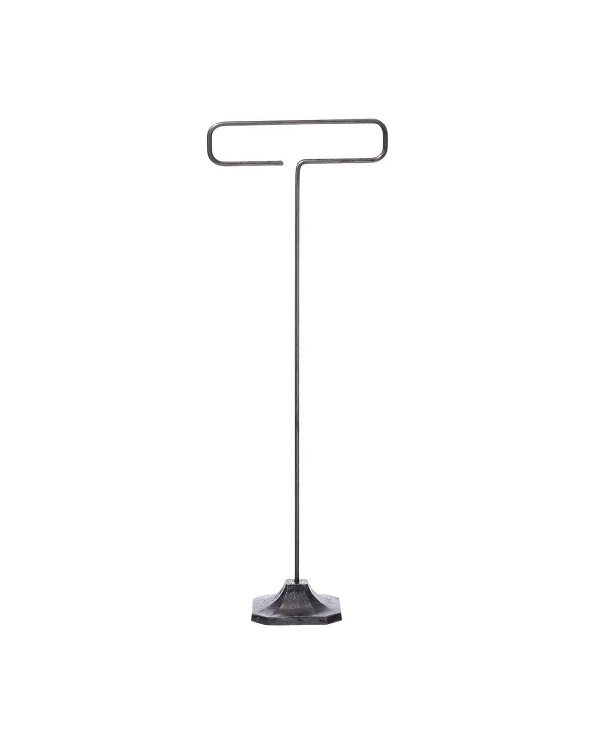 The Desk Wire Display Stand L by Faire features a minimalist design with a flat hexagonal base and a single steel rod that bends into a horizontal loop, creating a T-shape, all crafted from reclaimed steel. Shown against a plain white background.