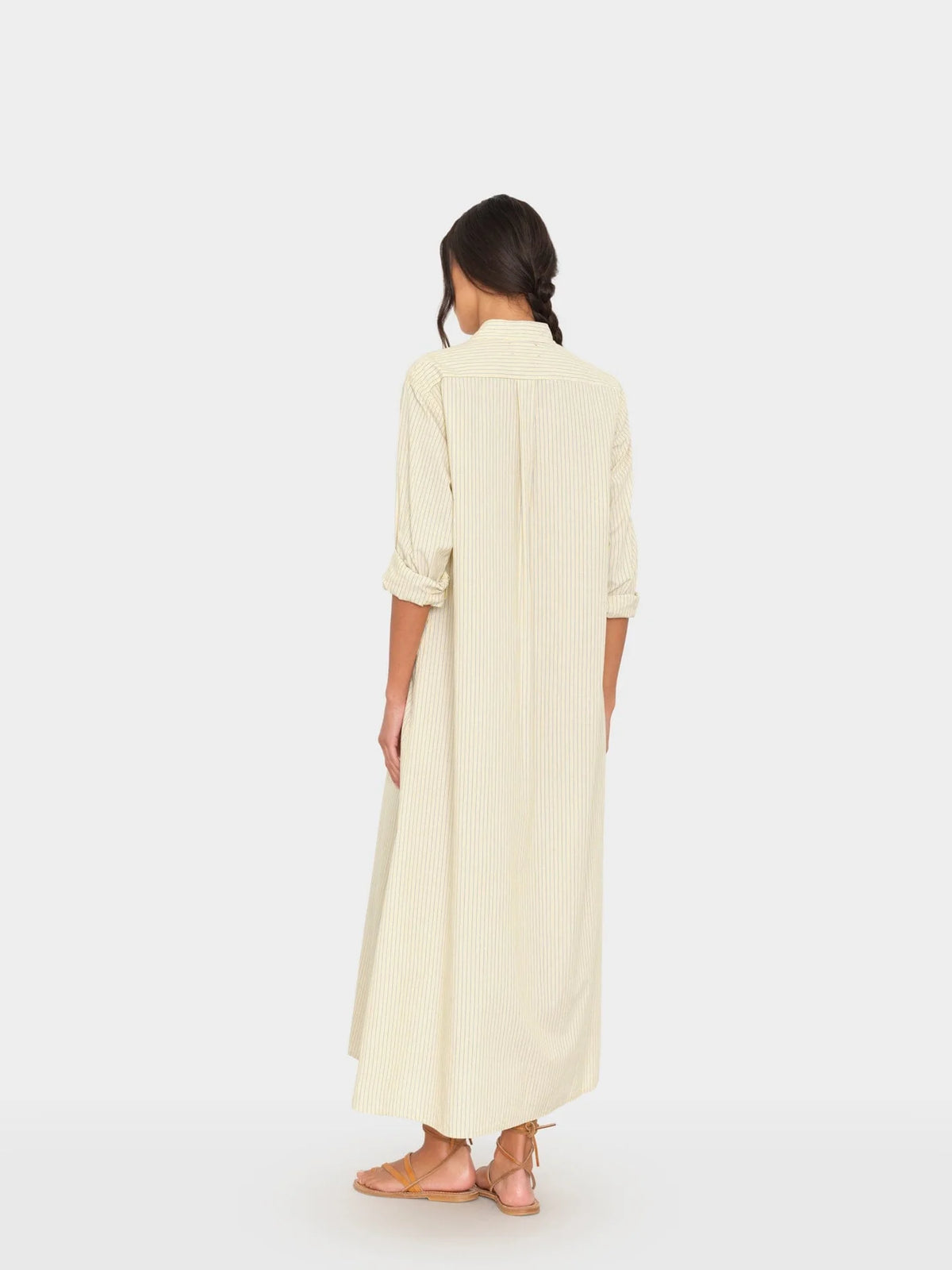 Xirena Boden long striped dress with rolled sleeves, styled with brown sandals for a relaxed, casual look.