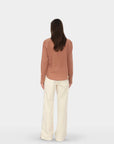 Xirena Bradshaw Pant with brown long-sleeve shirt, modern minimal style, neutral backdrop.