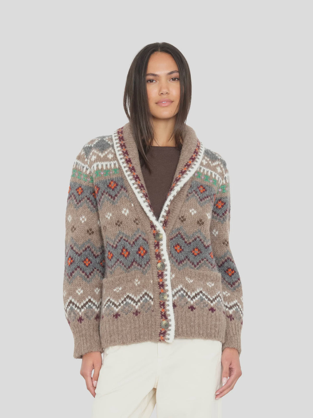 Xirena Vail Sweater in brown with colorful patterns, styled with cream pants against a neutral background.