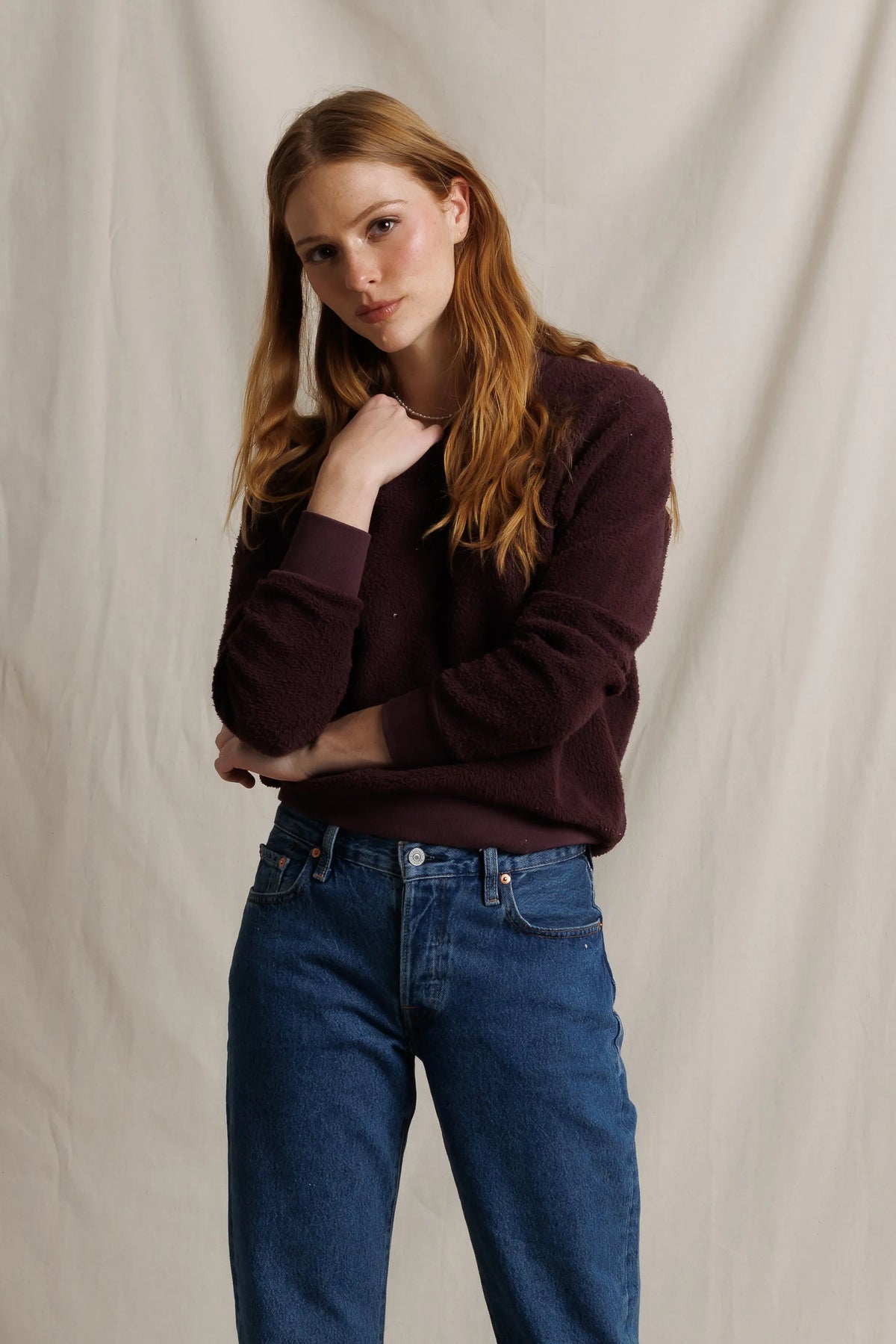 Ziggy Reverse LS Sweatshirt in Cherry Lacquer by Perfectwhitetee, worn by model with red hair against beige backdrop.