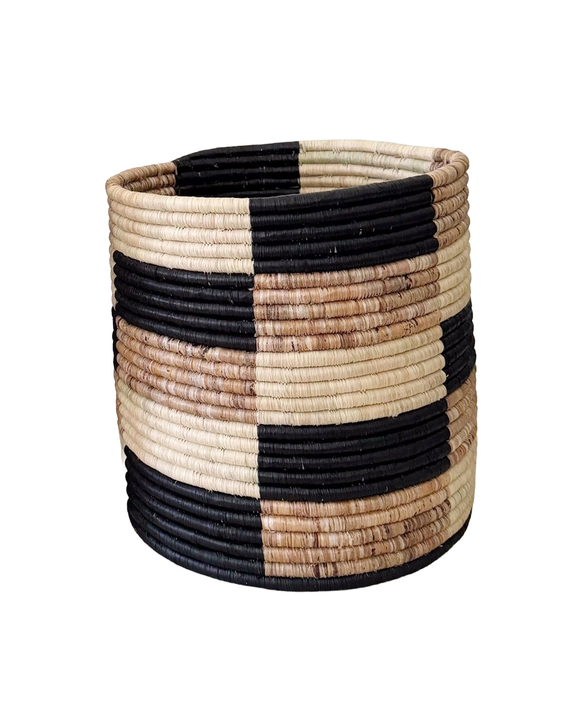The Storage Plant Basket: Zindiro by Faire is a round, handmade African basket with black, brown, and natural tan block-patterned stripes. This woven planter offers a sturdy design and open top.