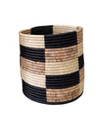 The Storage Plant Basket: Zindiro by Faire is a round, handmade African basket with black, brown, and natural tan block-patterned stripes. This woven planter offers a sturdy design and open top.